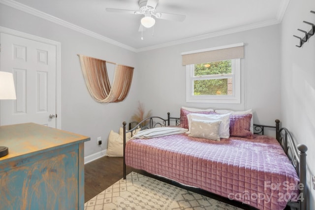 bedroom featuring dark wood-type flooring, ceiling fan, and ornamental molding