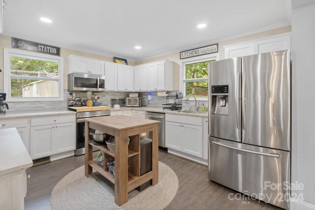 kitchen featuring dark hardwood / wood-style floors, appliances with stainless steel finishes, and white cabinetry