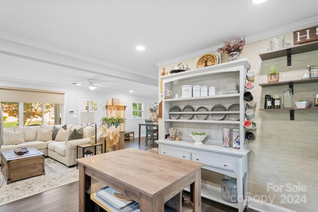 dining room with ornamental molding, wood-type flooring, and ceiling fan