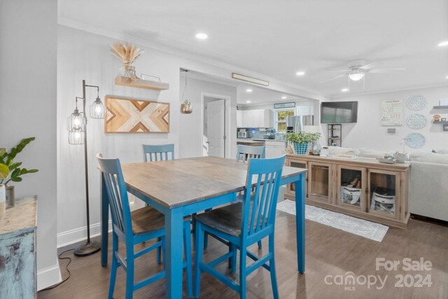 dining area with crown molding, ceiling fan, and hardwood / wood-style floors