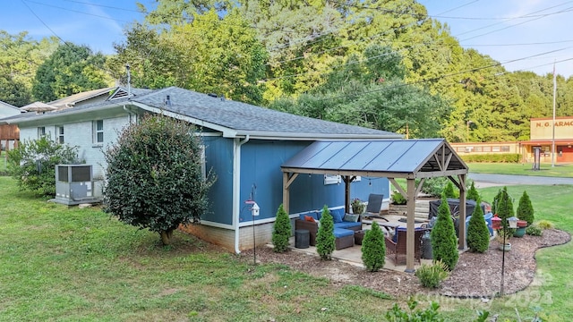 view of outdoor structure with a gazebo, a yard, and outdoor lounge area