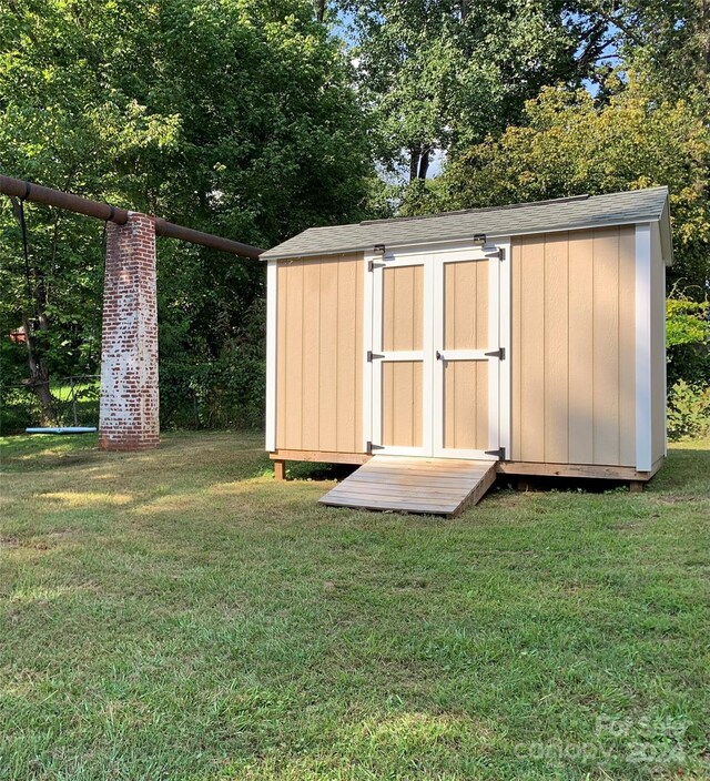 view of outbuilding with a lawn