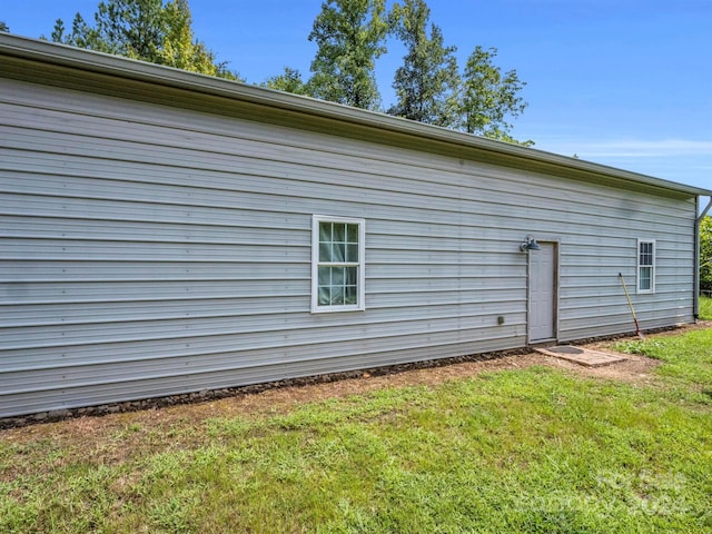 rear view of property featuring a lawn