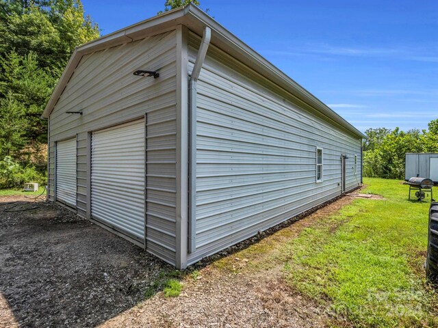 view of outbuilding featuring a yard