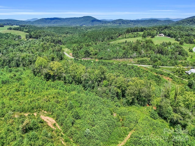 aerial view featuring a mountain view and a view of trees