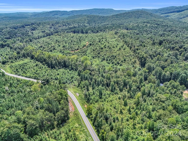 aerial view featuring a mountain view and a view of trees