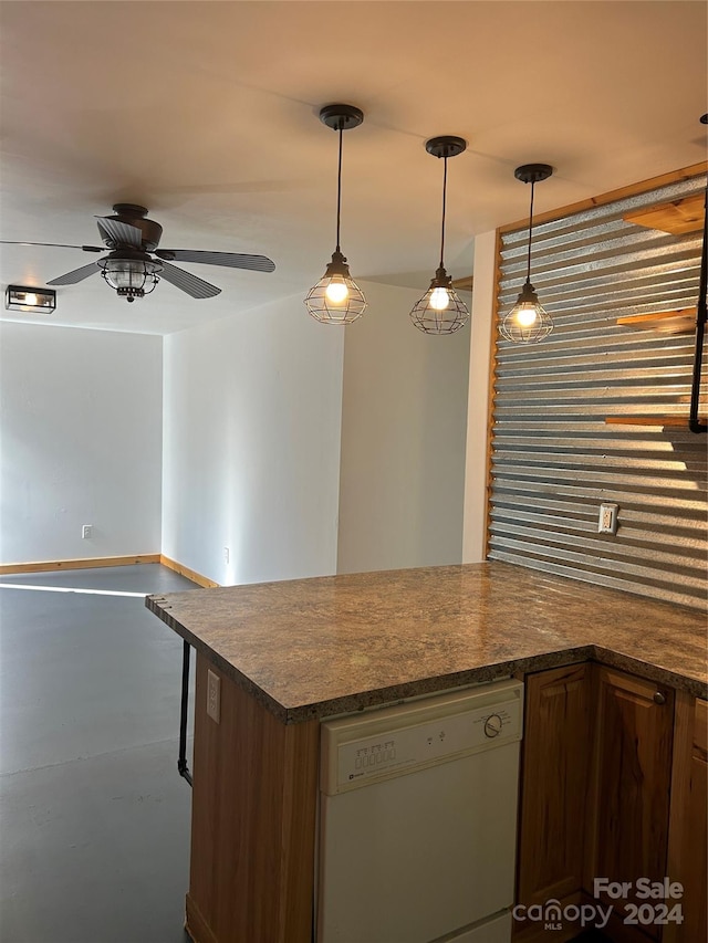 kitchen featuring finished concrete flooring, dark countertops, ceiling fan, white dishwasher, and pendant lighting