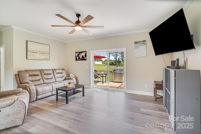 living room with a ceiling fan, light wood-type flooring, crown molding, and baseboards