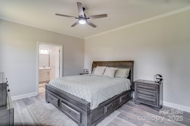 bedroom featuring light wood-type flooring, baseboards, ensuite bathroom, and ornamental molding