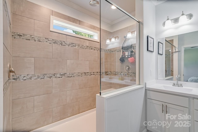 ensuite bathroom with tiled shower, connected bathroom, vanity, and crown molding