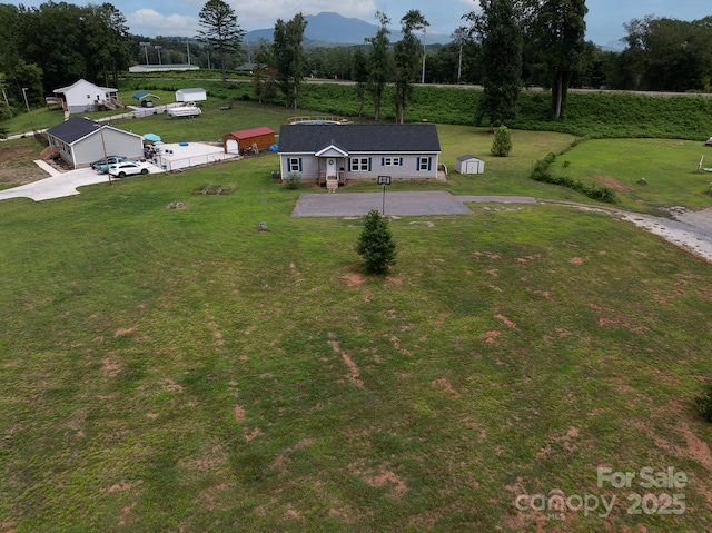 birds eye view of property with a mountain view