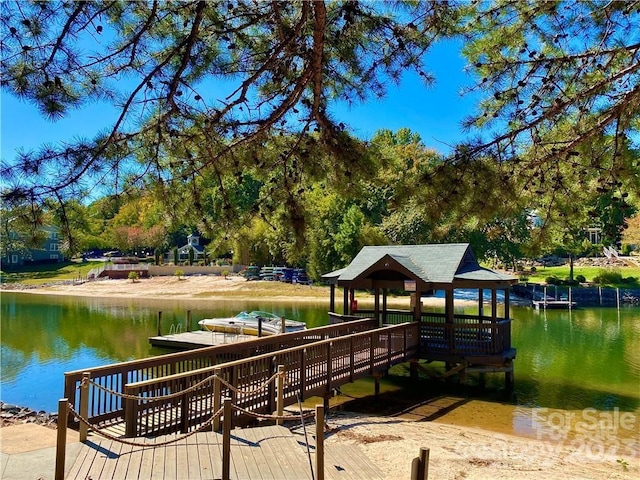 view of dock with a gazebo and a water view