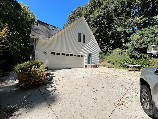 view of side of home featuring a garage