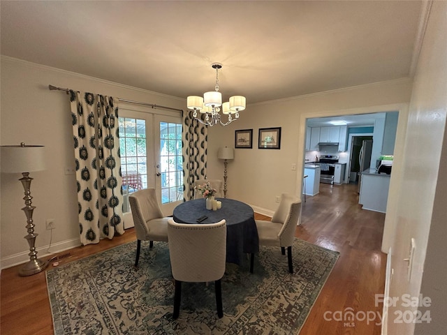 dining area with crown molding, french doors, a notable chandelier, and dark hardwood / wood-style floors