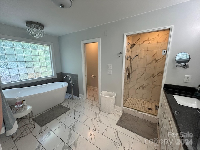 bathroom featuring shower with separate bathtub and vanity