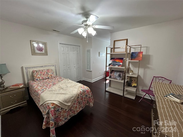 bedroom featuring ceiling fan, dark hardwood / wood-style floors, and a closet