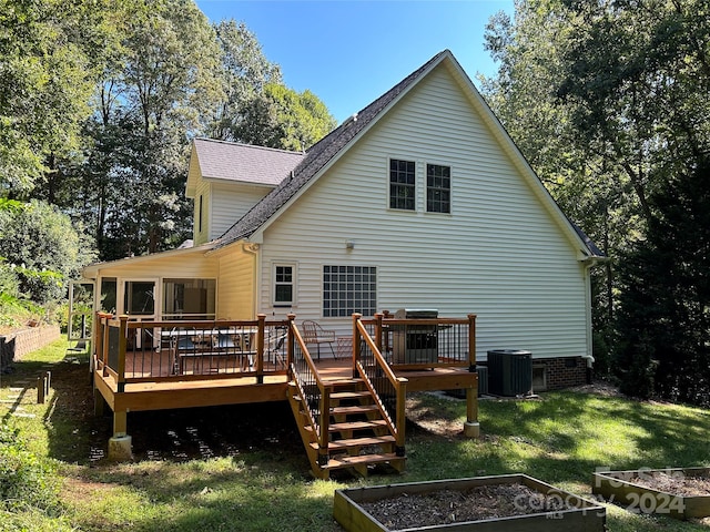 back of house with a yard, central AC unit, and a deck