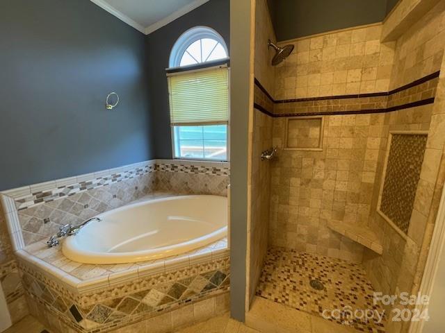 bathroom featuring tile patterned floors, independent shower and bath, and ornamental molding