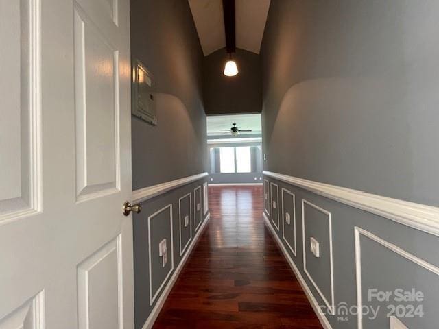 hallway featuring vaulted ceiling with beams and dark hardwood / wood-style floors