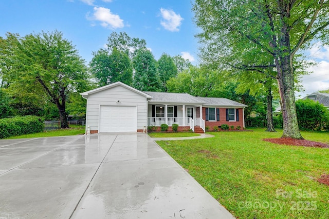 ranch-style home featuring covered porch, a front yard, and a garage