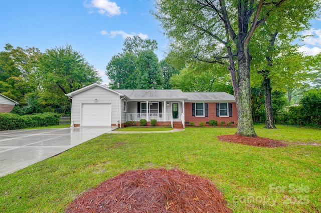 ranch-style house with a porch, a garage, and a front yard