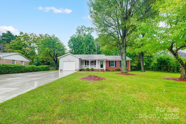 ranch-style home with covered porch, a front yard, and a garage