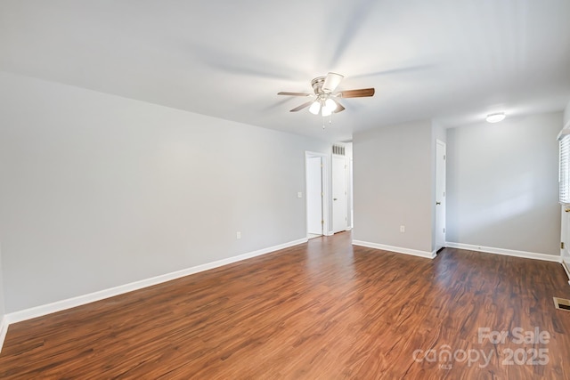 unfurnished room featuring ceiling fan and dark hardwood / wood-style flooring