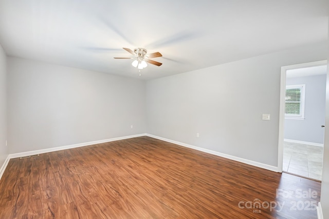 unfurnished room with ceiling fan and wood-type flooring