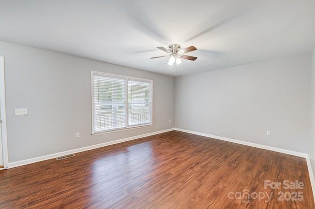 unfurnished room with dark hardwood / wood-style floors and ceiling fan