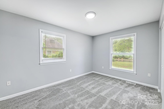 carpeted empty room featuring a healthy amount of sunlight