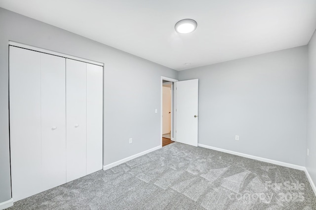 unfurnished bedroom with carpet and a closet