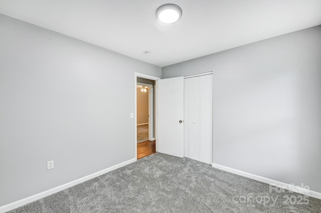 unfurnished bedroom featuring carpet flooring and a closet