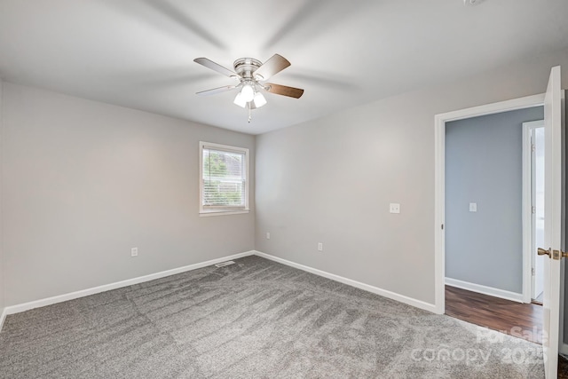 empty room with ceiling fan and carpet flooring