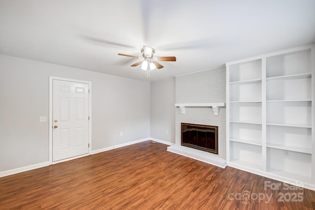 unfurnished living room with a brick fireplace, ceiling fan, and hardwood / wood-style floors