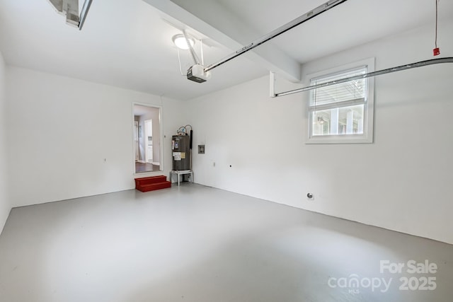 garage with a garage door opener and electric water heater