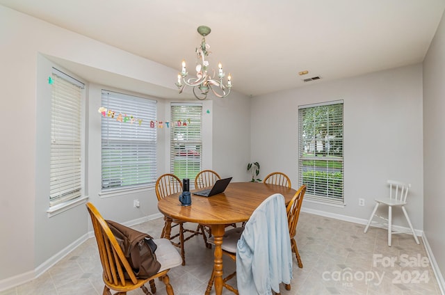 dining space featuring a wealth of natural light, a chandelier, and light tile patterned floors