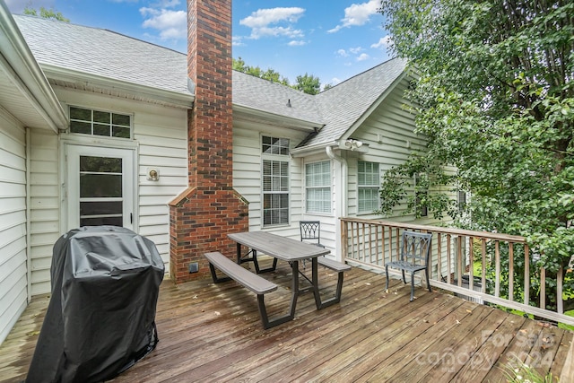 wooden deck featuring a grill