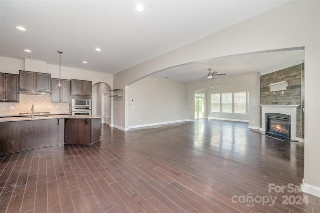 kitchen with appliances with stainless steel finishes, dark hardwood / wood-style floors, pendant lighting, and ceiling fan