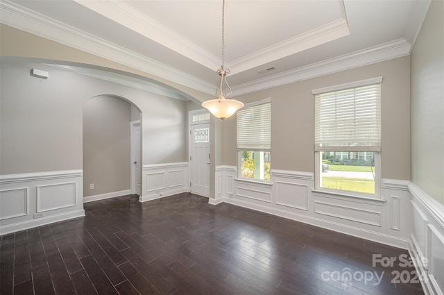 unfurnished room with crown molding, a tray ceiling, and dark hardwood / wood-style floors