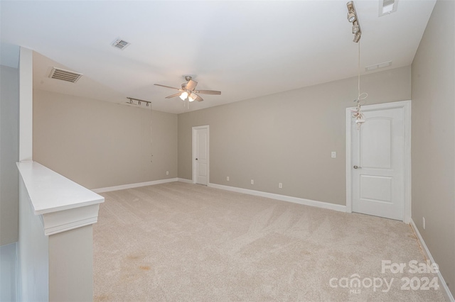 carpeted spare room with ceiling fan