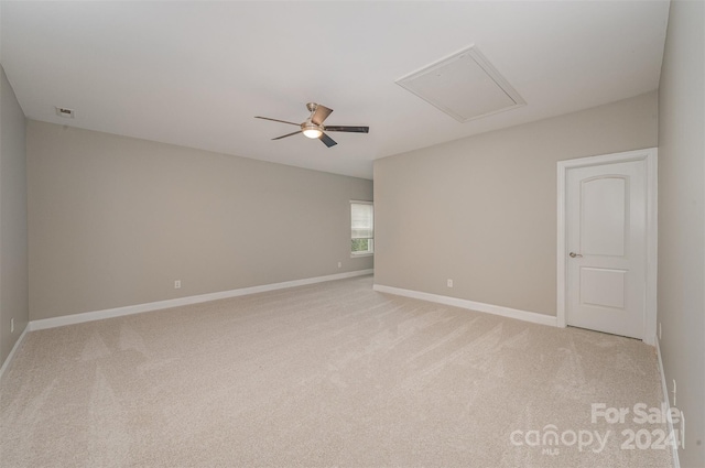 unfurnished room featuring ceiling fan and light colored carpet