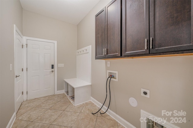 washroom with cabinets, electric dryer hookup, hookup for a washing machine, and light tile patterned flooring