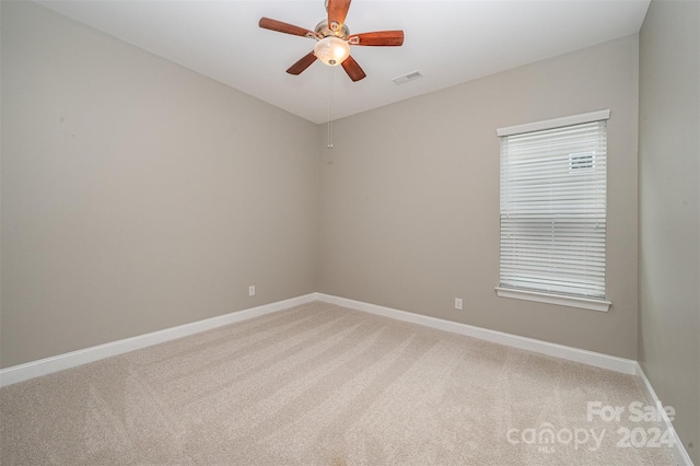 unfurnished room with ceiling fan and carpet