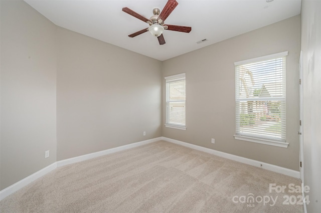 carpeted empty room featuring ceiling fan