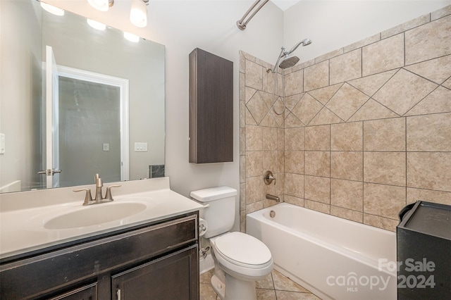 full bathroom with tile patterned flooring, tiled shower / bath combo, vanity, and toilet