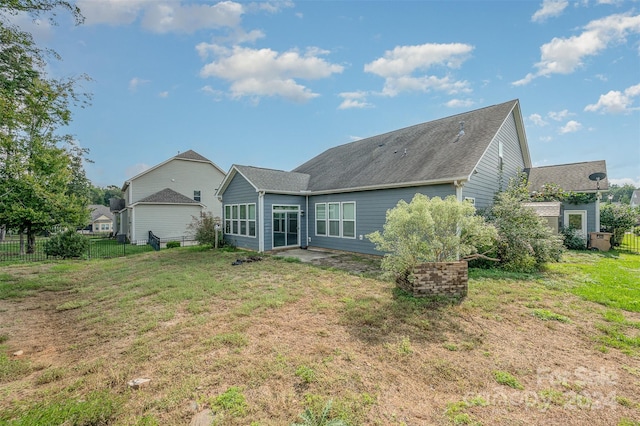 back of house featuring a yard