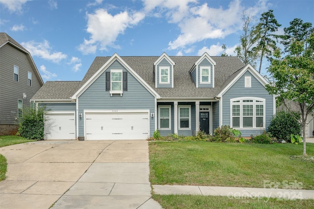 view of front of home featuring a front yard and a garage