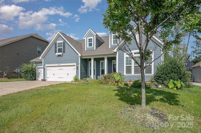 view of front of property with a garage, a front yard, and concrete driveway