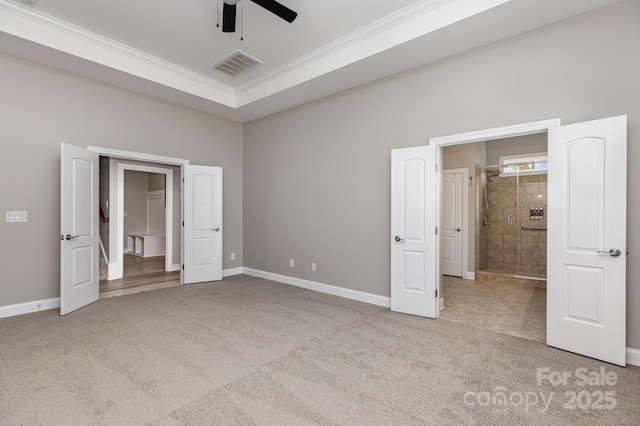 unfurnished bedroom with crown molding, carpet, a ceiling fan, baseboards, and visible vents