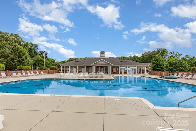 community pool featuring a patio and fence